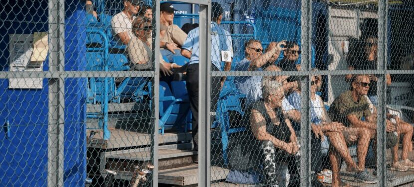 Spectators sit in blue stands at the Danish National Softball Championships 2024