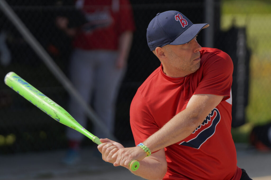 man with softball bat